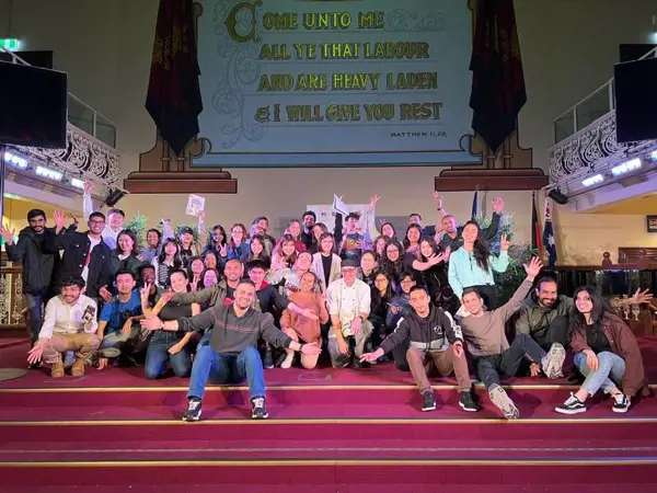Group of people posing for the camera in the main auditorium