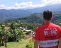 Man overlooking a village on the Kokoda Track