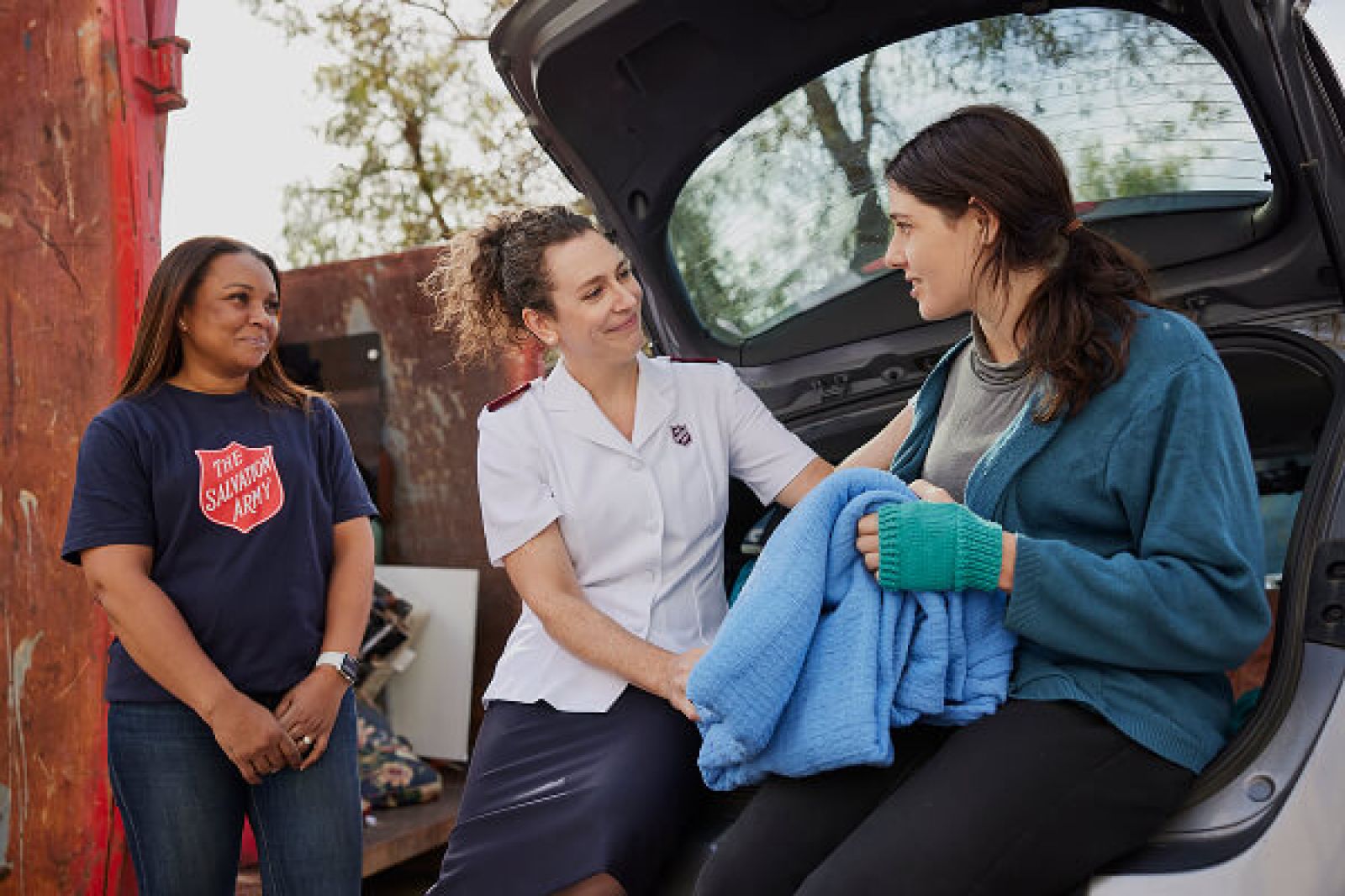 Salvos personnel helping a community member in need