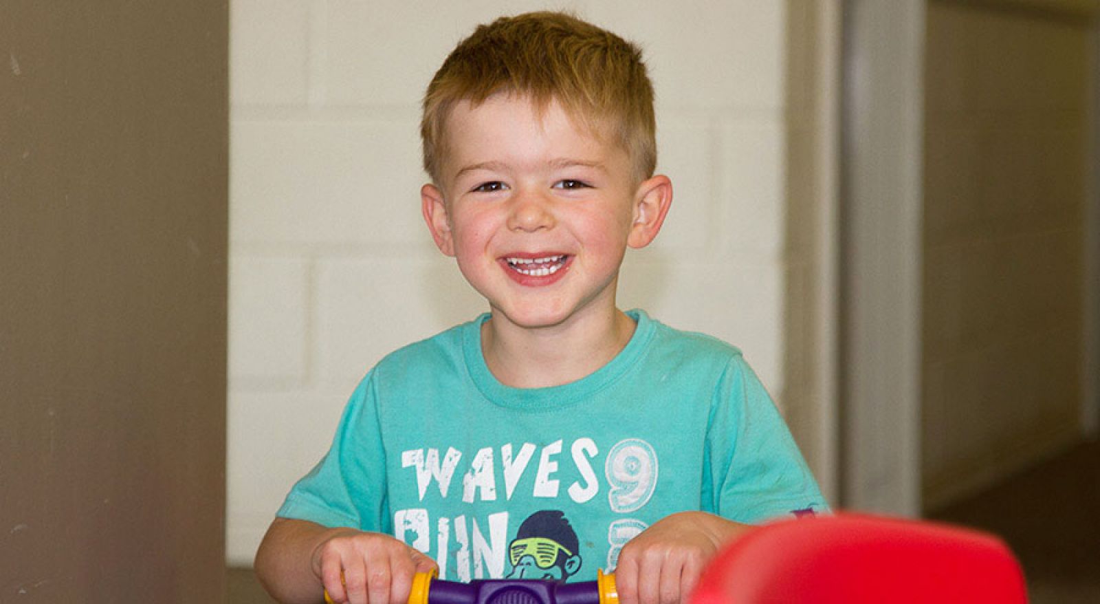 child playing on scooter