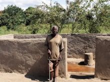 Nicholas at the village borehole. [Credit: The Salvation Army Malawi Territory]
