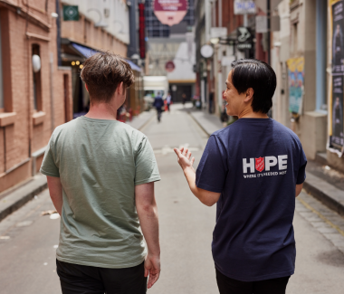 Salvation Army Officer walking and chatting with a young man
