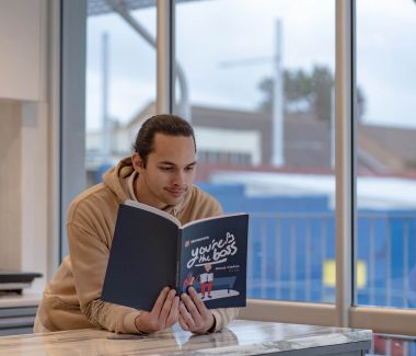 Troy turns tough lessons into Moneycare message for students