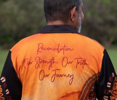 The back of a t-short stating the phrase reconciliation our strength our truth our journey