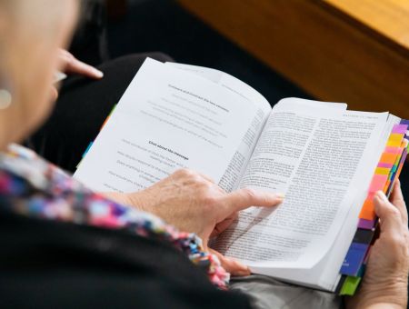CLose-up of a woman reading the Bible.