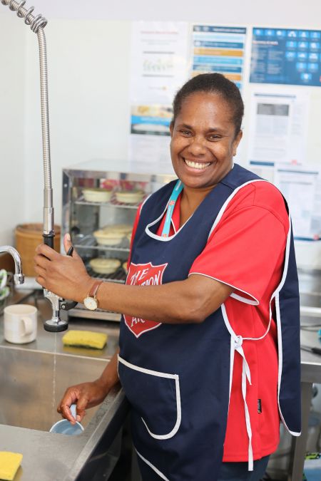 Volunteer washing dishes
