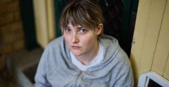 Emily looking at the camera with a sad expression on her face.