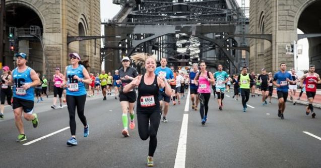 girl running and smiling on Sydney Harbour Bridge