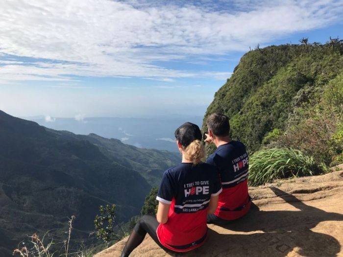 Two trekkers overlooking the mountains and a valley