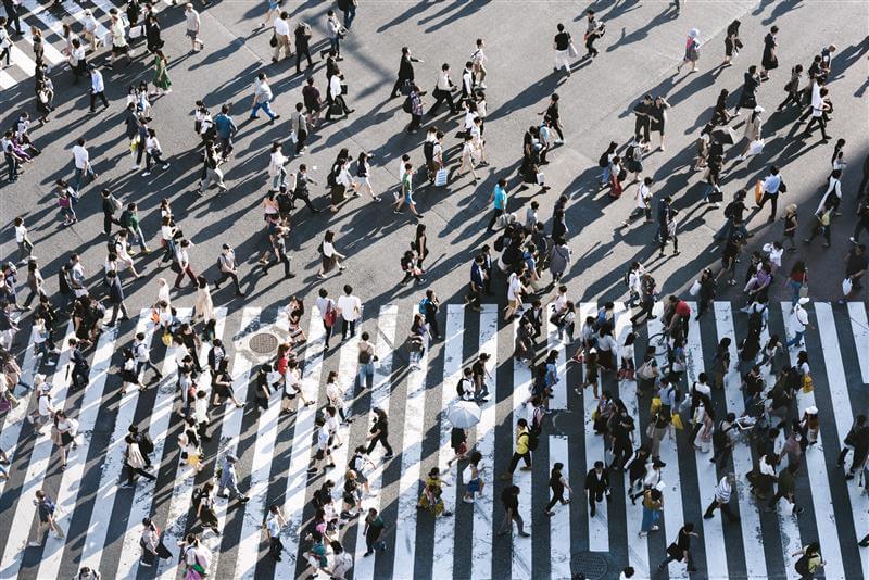 People walking through a busy crosswalk