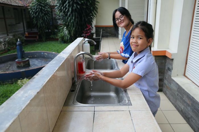 two females washing hands