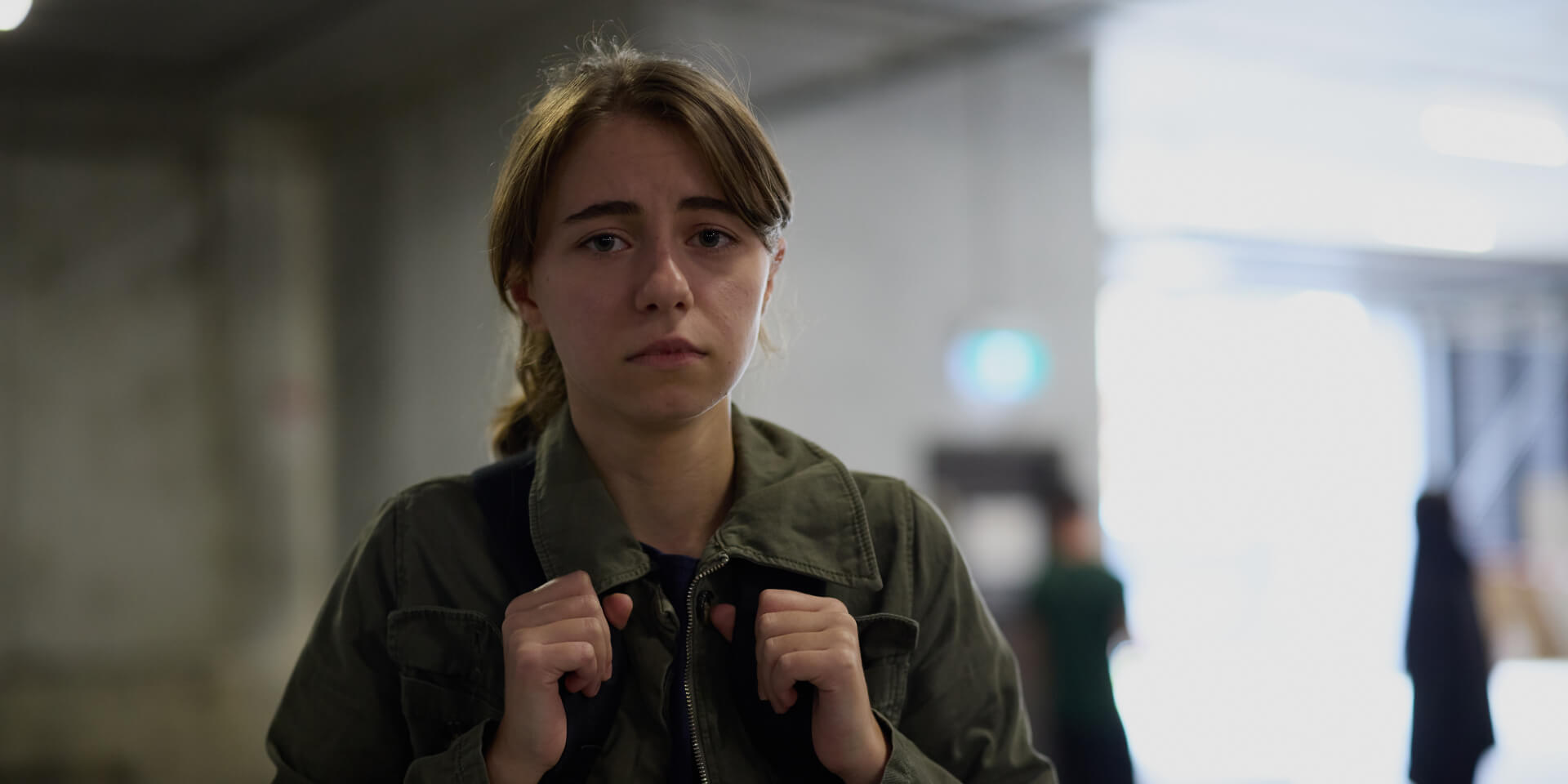 Ava carrying a backpack looking distressed