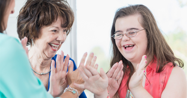 Mother playing clapping game with daughter
