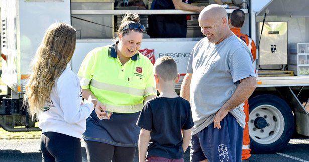 Father and his kids chatting to a Salvos Emergency volunteer