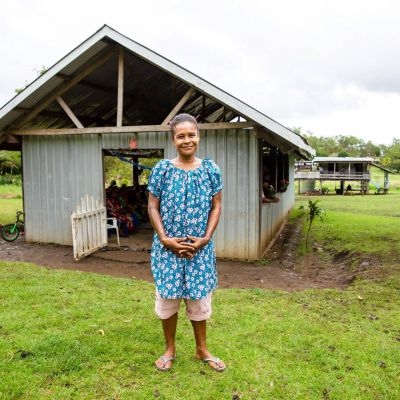 Woman standing in front of a Salvation Army refuge building.