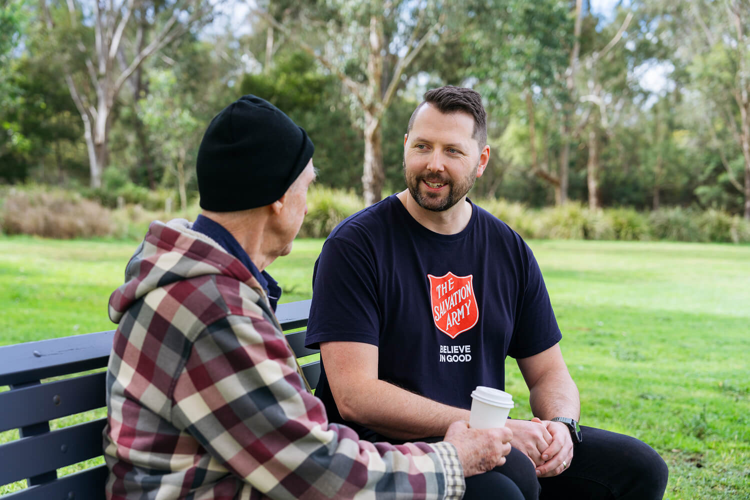Salvos team member walking with a community member