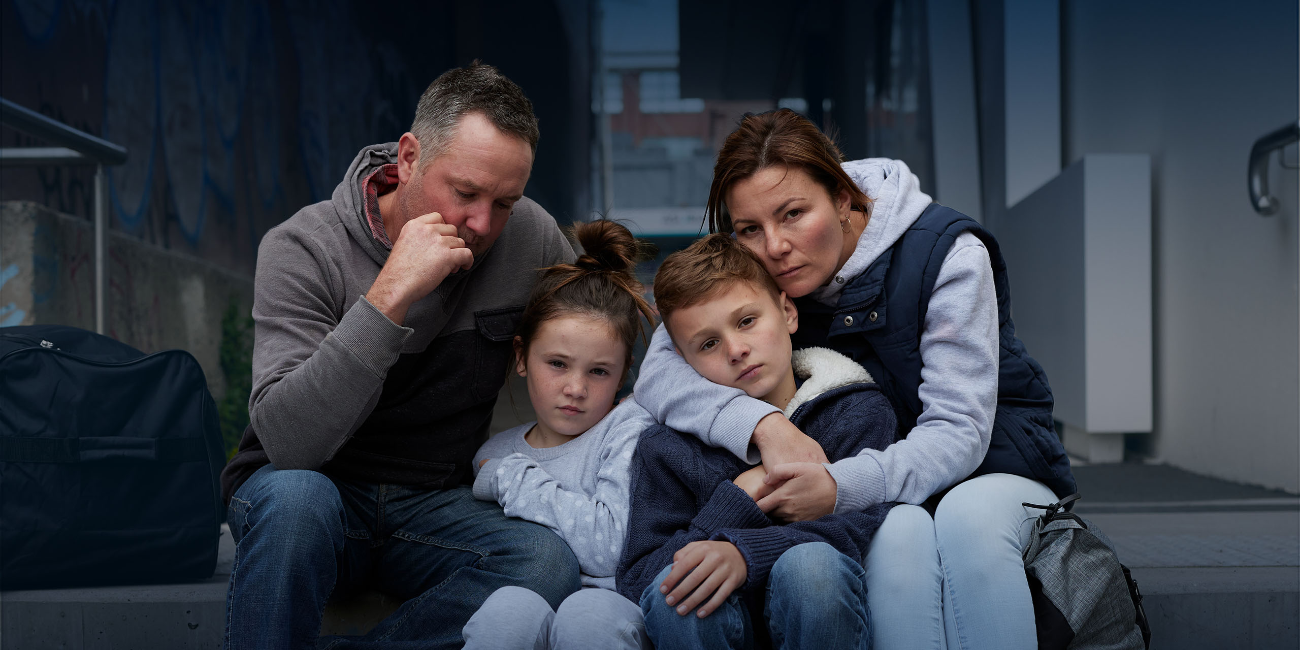 A family huddling on a doorstep