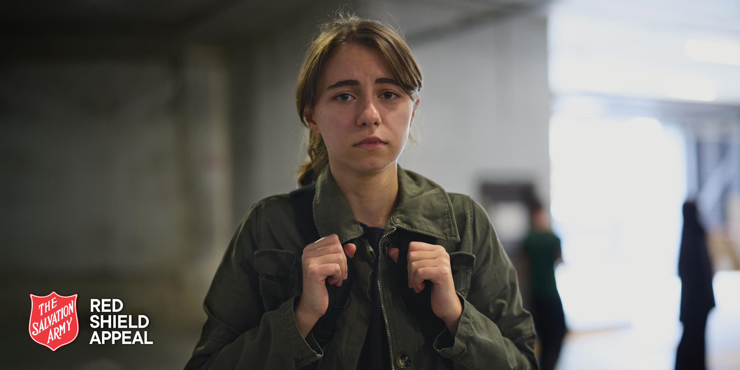 Ava carrying a backpack and looking distressed