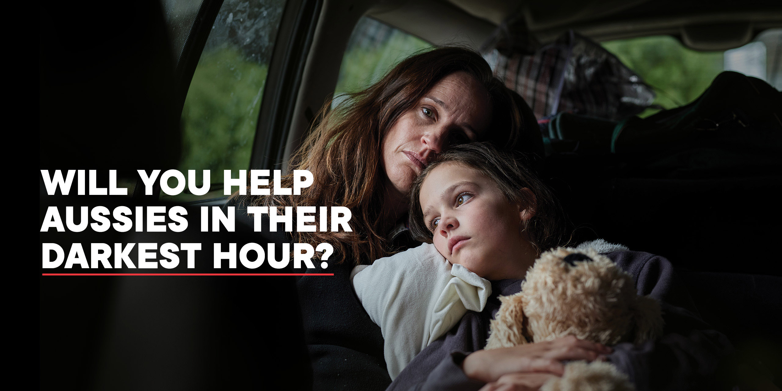 A mother and child sheltering in their car at night