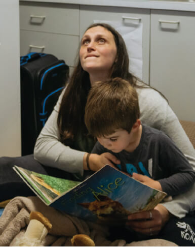 A mother and son read together.