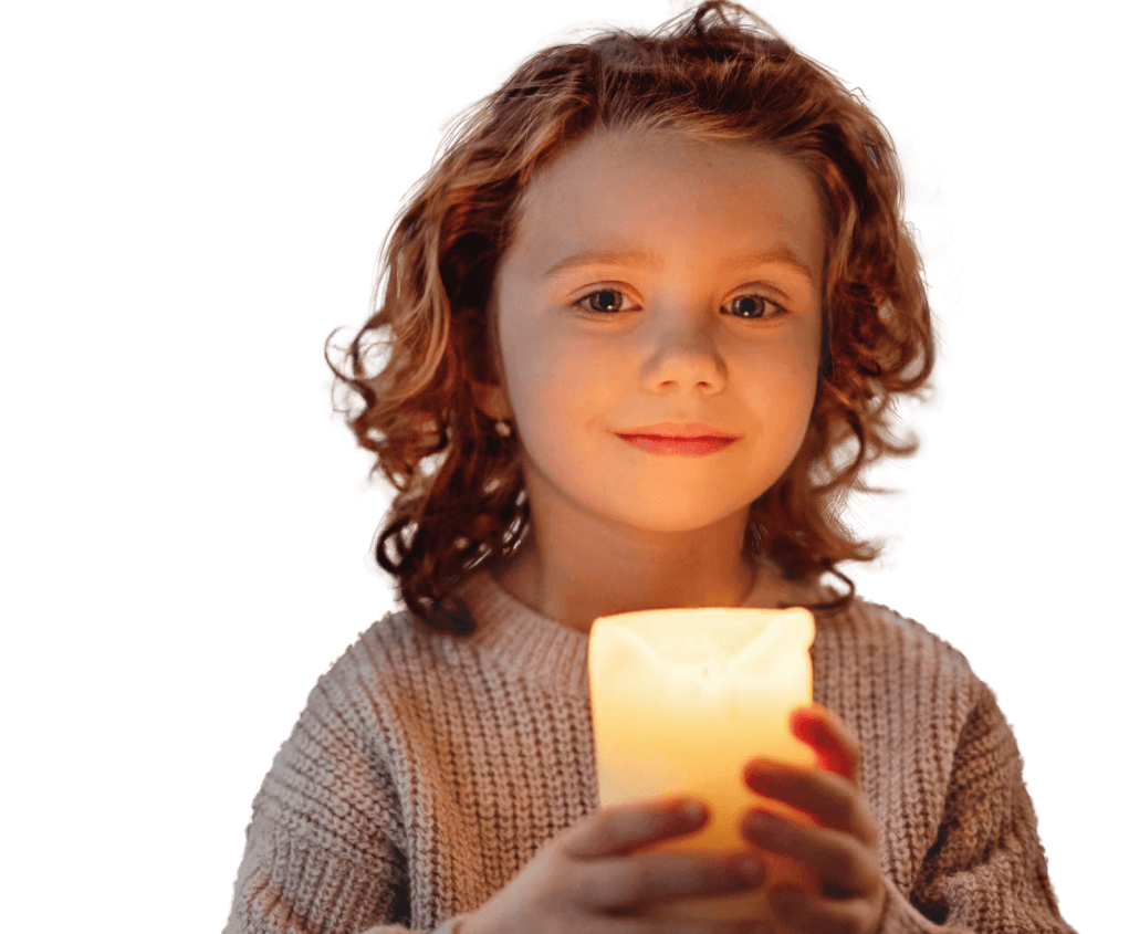 A child holding a glowing Christmas candle