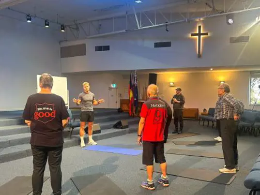 A small personal training group of men in a Salvos church