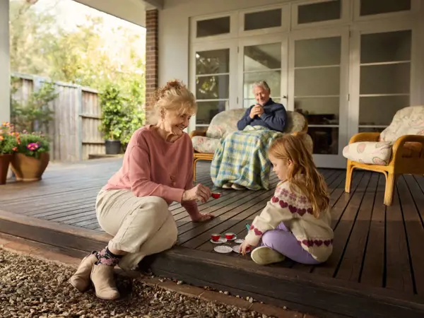 Two grandparents spend some time with their young granddaughter.