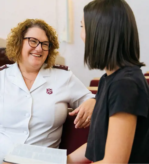 A young woman chats with a Salvos officer.