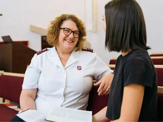 A young woman chats with a Salvos officer.