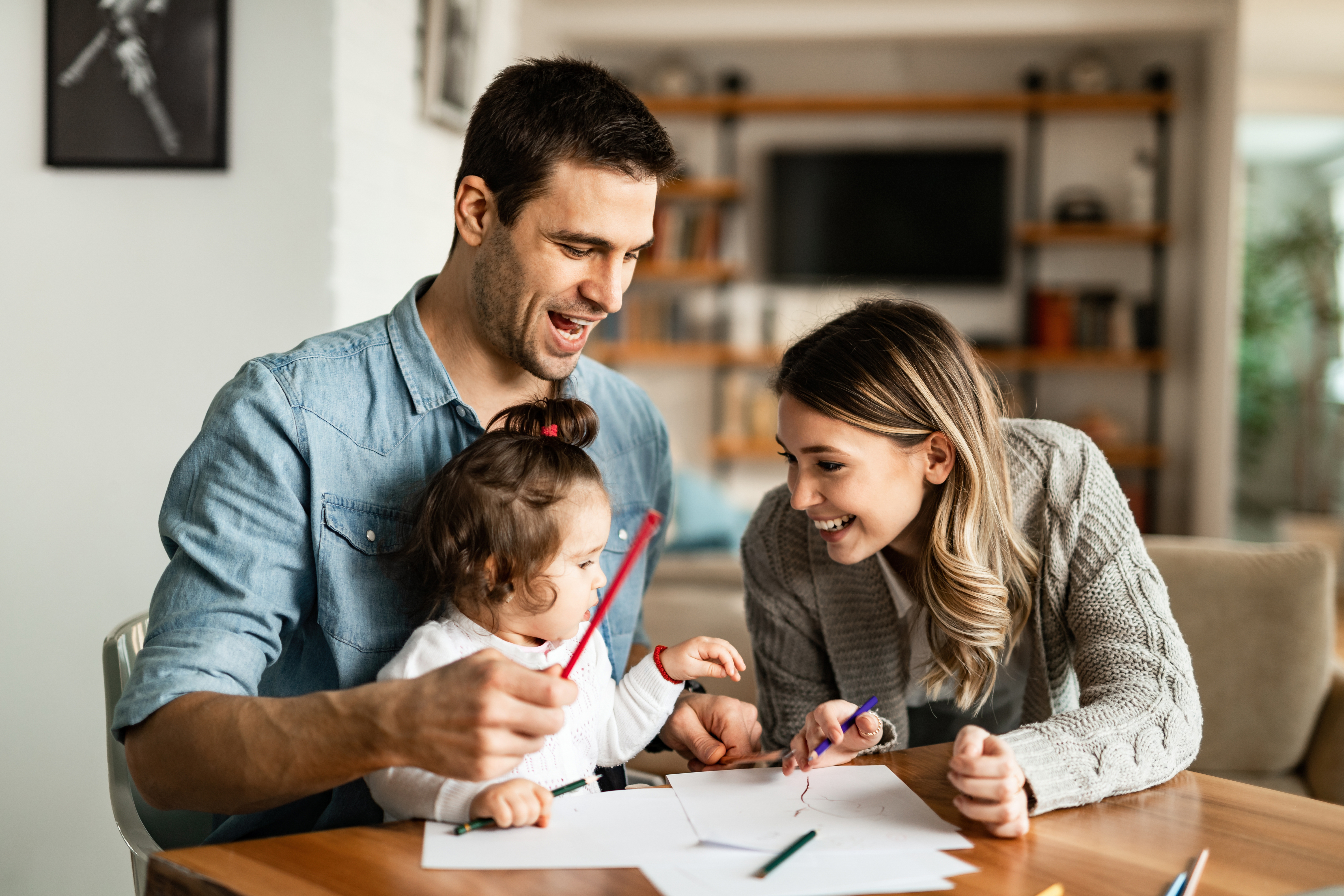 Parents with their young daughter at a table