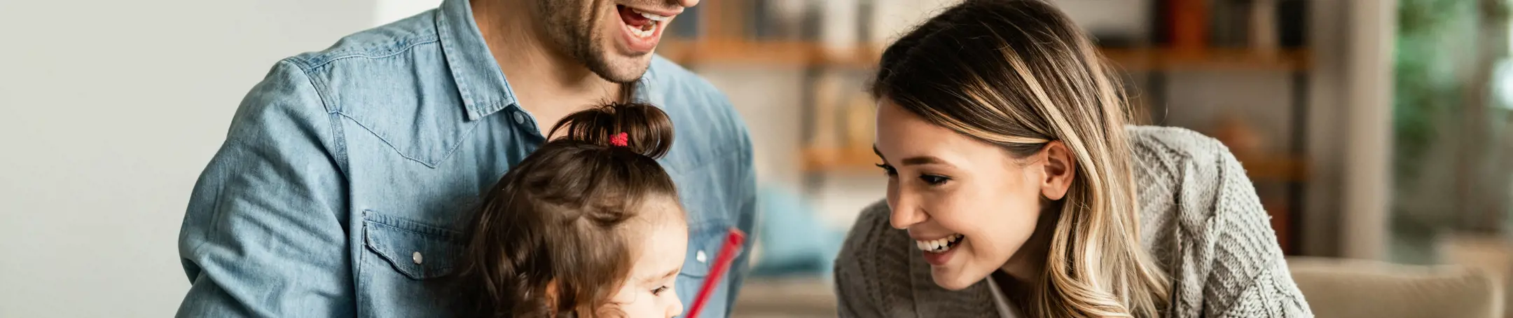 Parents with their young daughter at a table