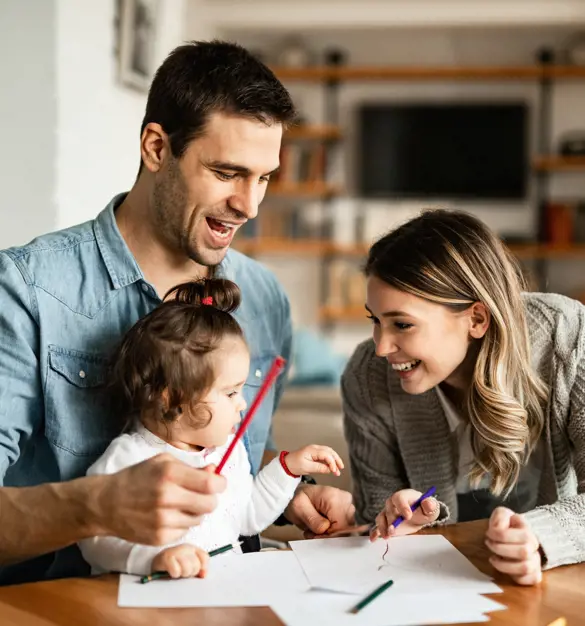 Parents with their young daughter at a table