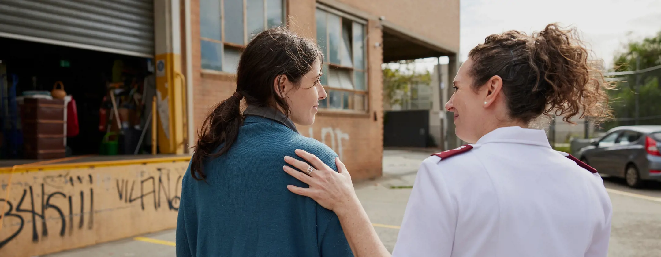 A Salvation Army officer offers a gesture of comfort to a person needing support.
