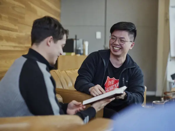 A Salvos worker works on new strategies with a client.