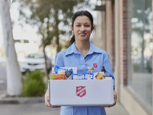 A woman holding a hamper.