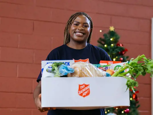 Woman holding a box of donated food