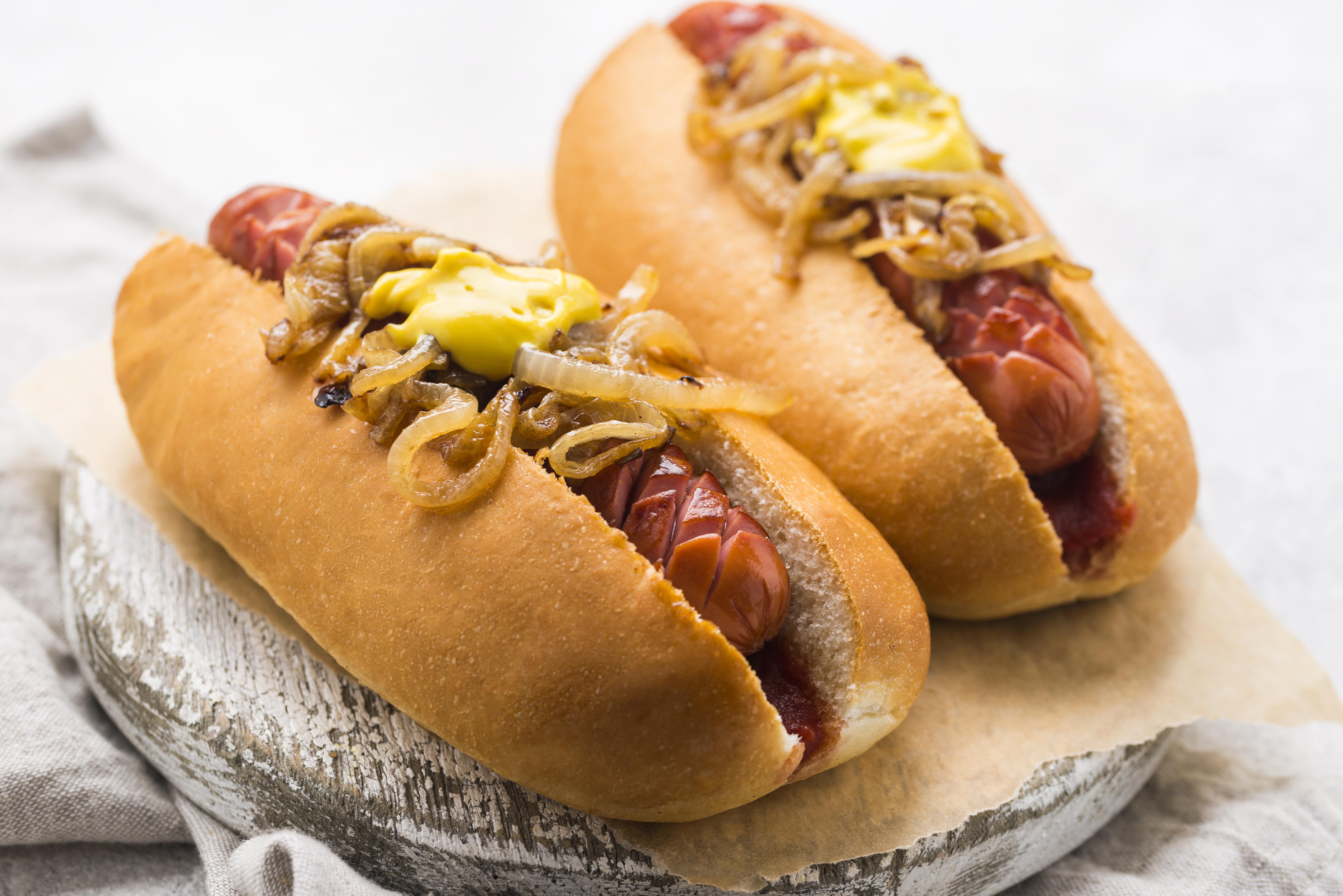 two hot dogs on a food board