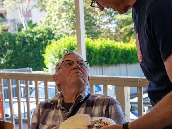 Man being served lunch