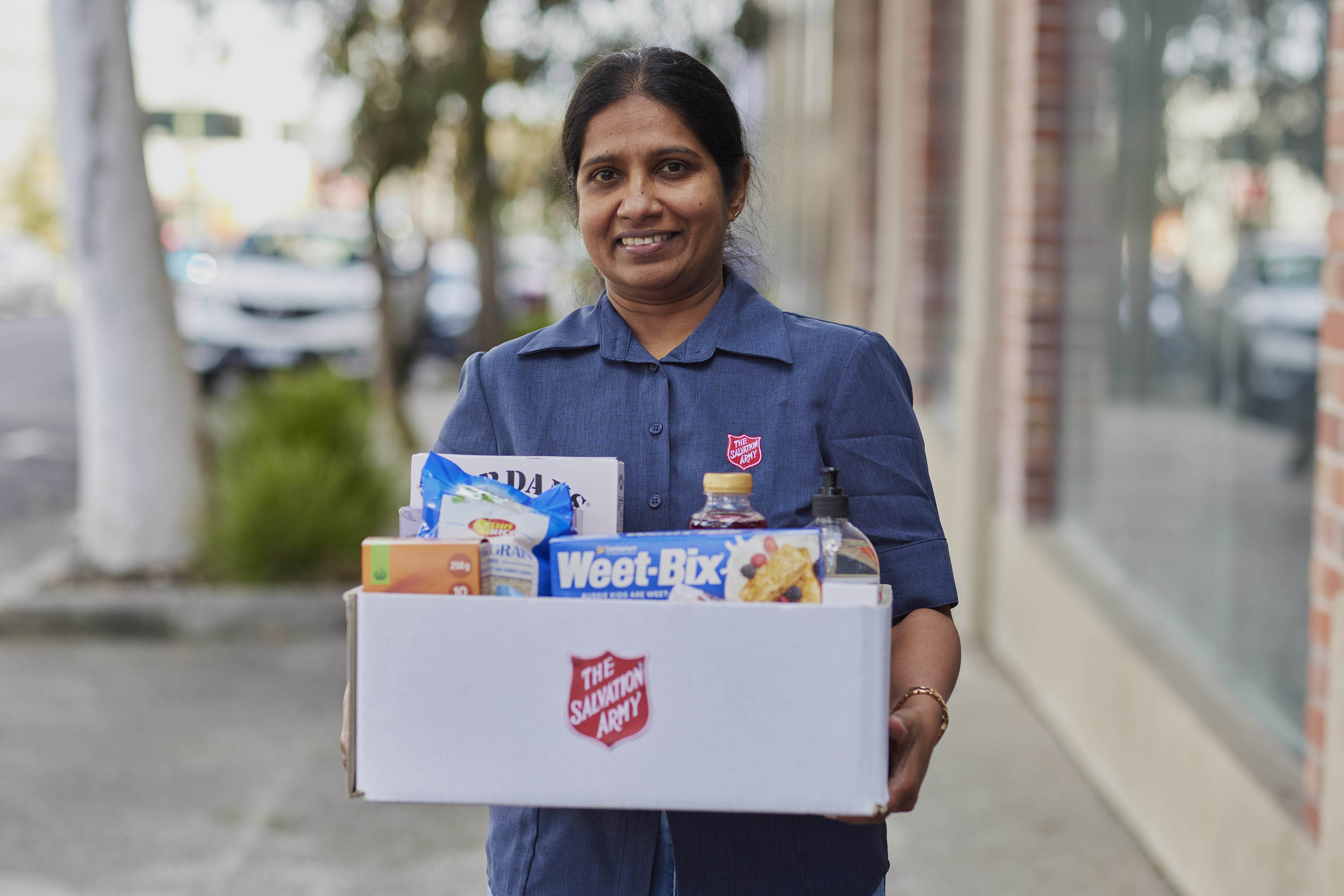 Woman with box of donated goods