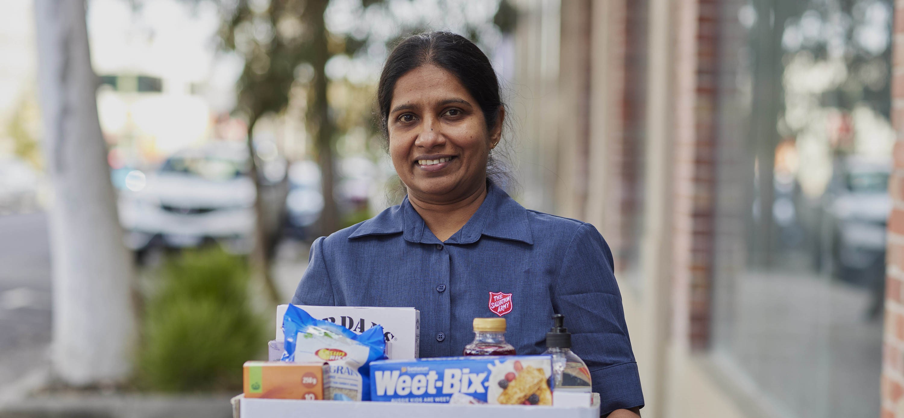 Woman holding box of donated items