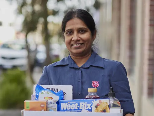 Woman holding box of donated items
