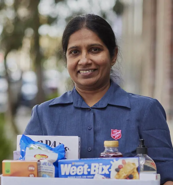 Woman holding box of donated items