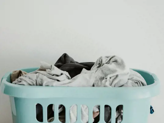 Basket of clothing for laundry.