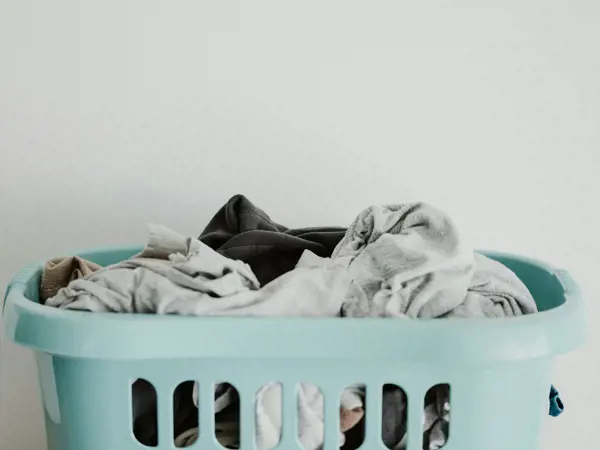 Basket of clothing for laundry.