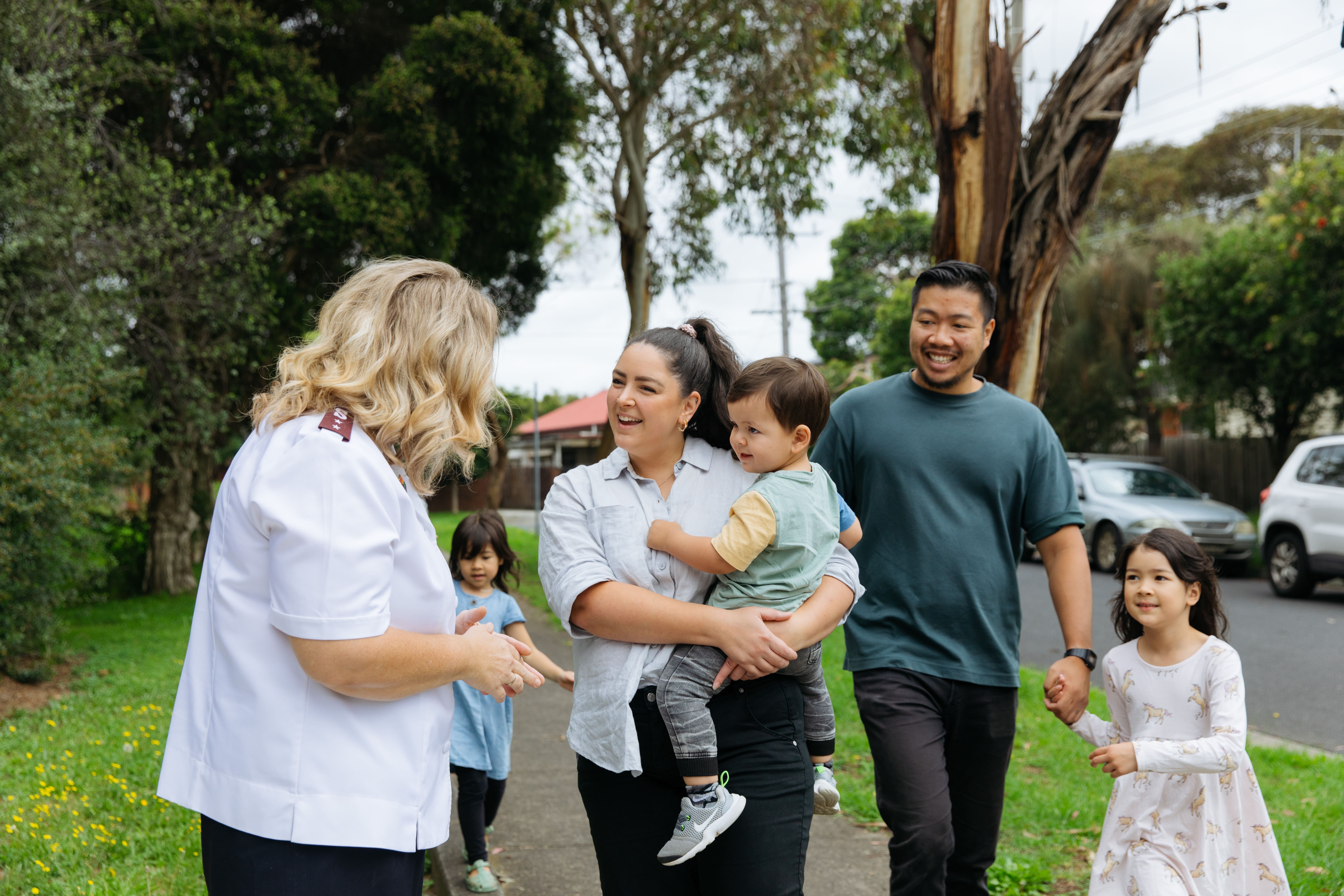 Officer with community members on sidewalk