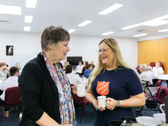 Two women talking while drinking tea