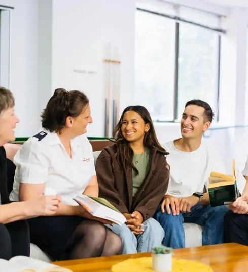 People conversing around coffee table