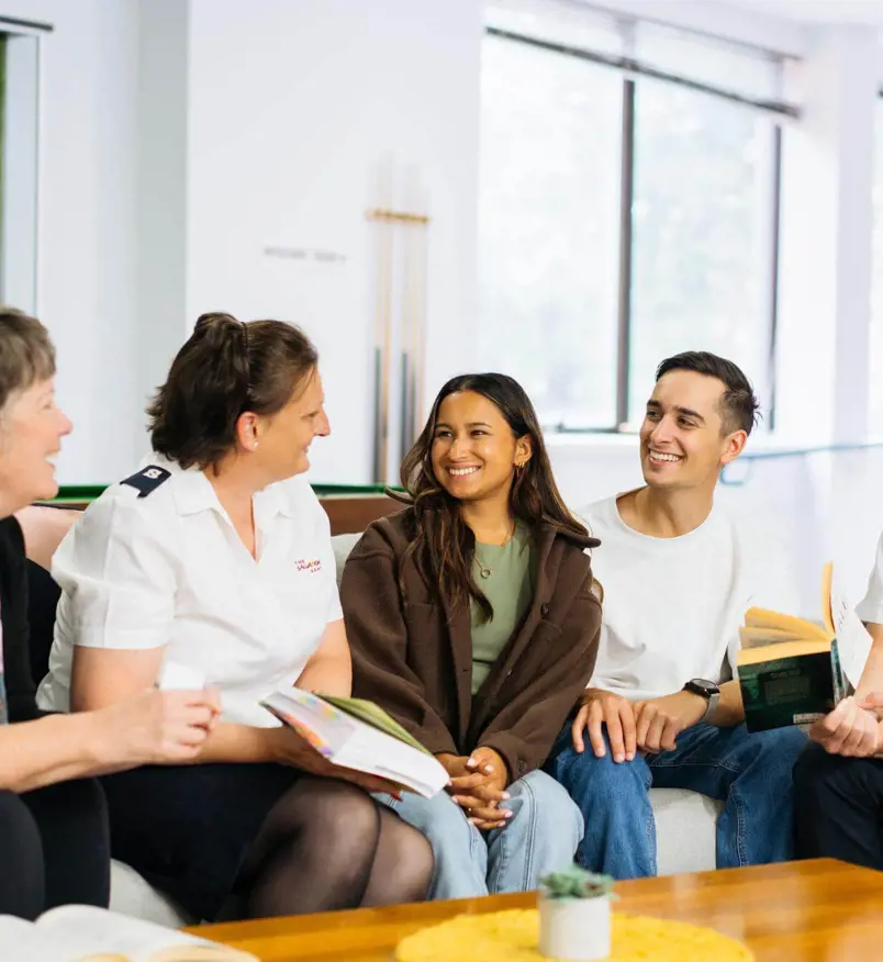 People conversing around coffee table