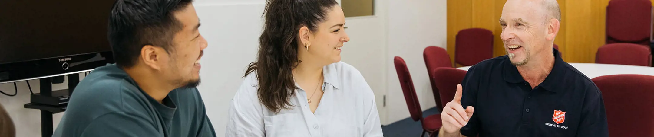 Salvos team member chatting with a young family