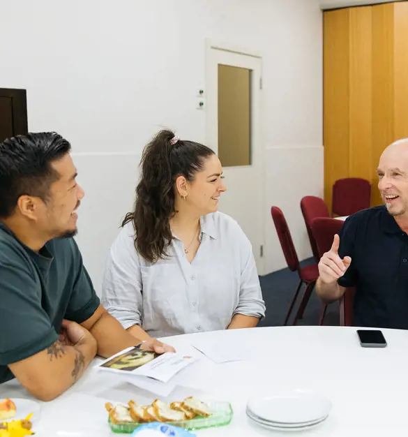 Salvos team member chatting with a young family
